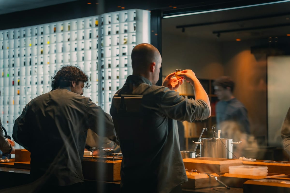 A kitchen team preparing food together during prep