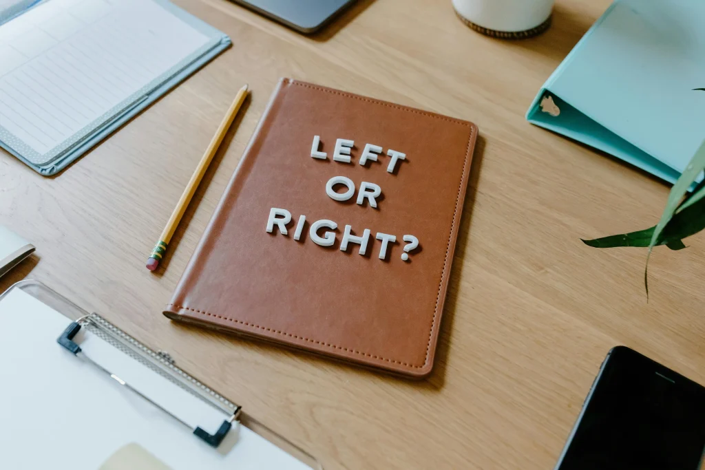 A notebook on a desk with "Left or Right?" written on it, symbolizing decision-making and tips for landing jobs in hospitality.